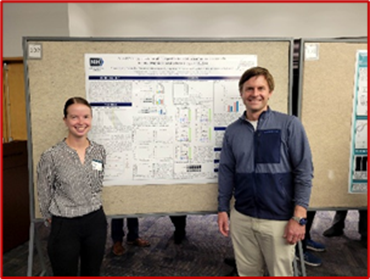 Athena Apfel standing by her poster with her mentor Dr. Chris Grunseich
