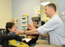 Image of Dr. Bonnemann examining a pediatric patient.
