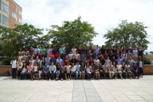 A large group photo of NINDS summer interns outside at the NIH campus.